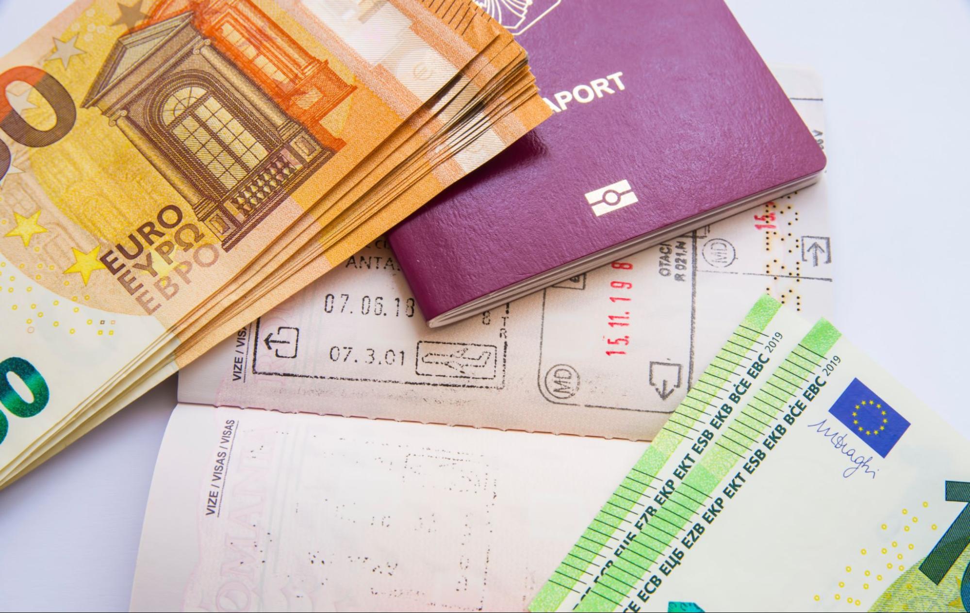 Close image of euro currency and passport visa stamps