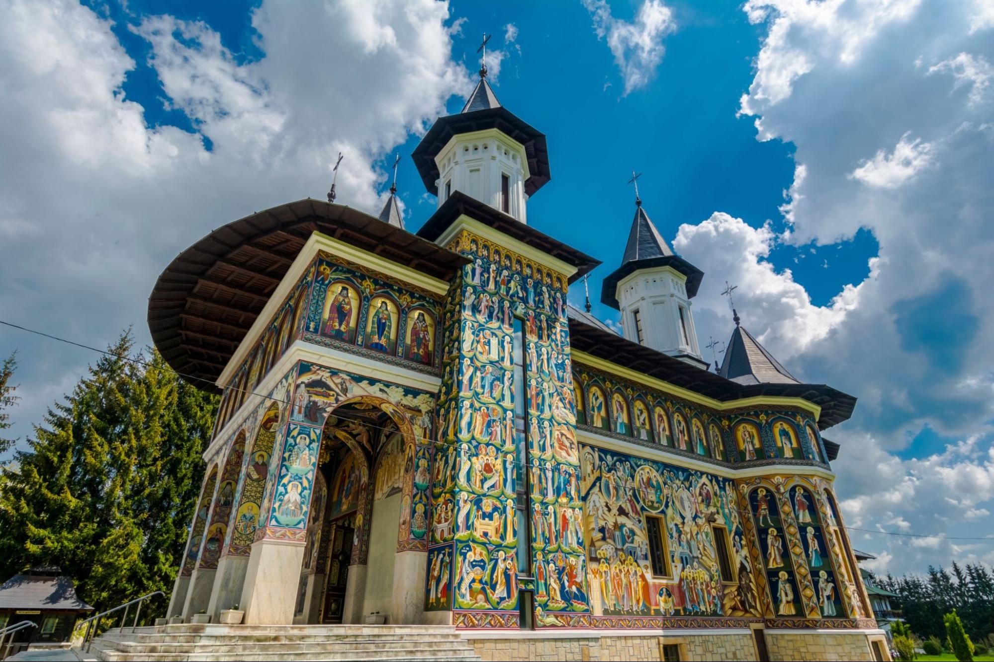 Colorful facade mural painted fresco at Neamt Monastery, Romania
