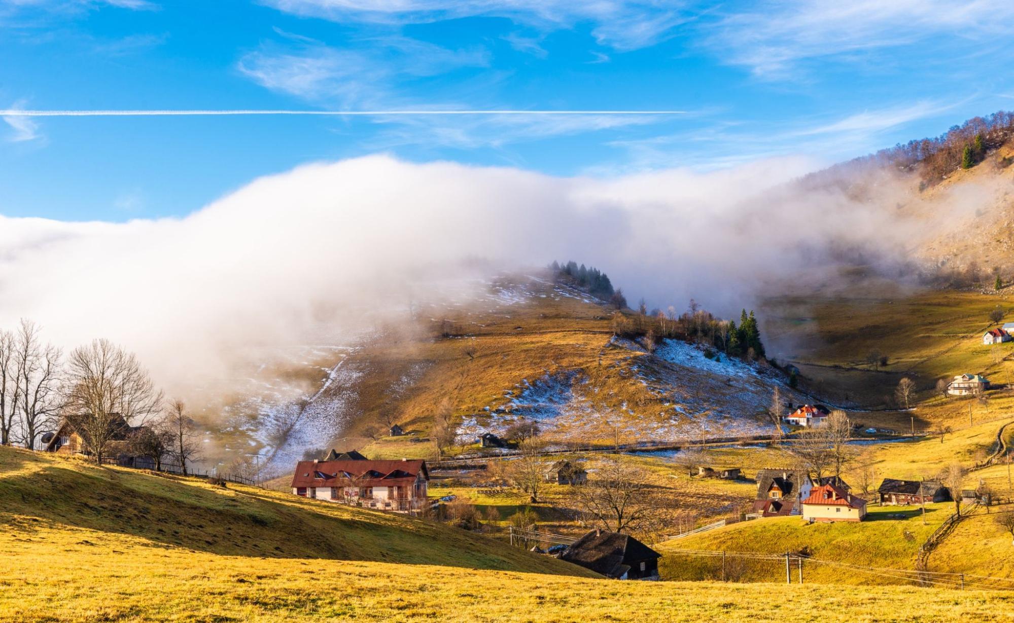 Rural landscape with fog in Sirnea – Fundata village, Transylvania landmark, Romania